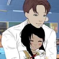 Cute guy hugging his girlfriend at the classroom